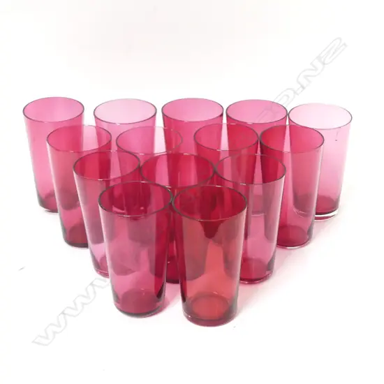 Thirteen cranberry glass small beakers