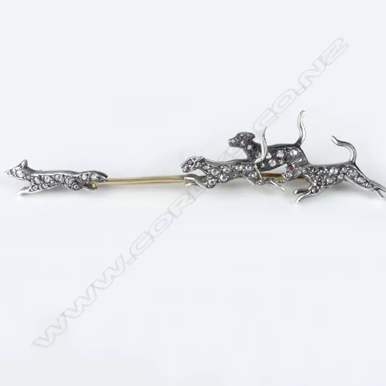 A decorative gold silver and diamond set fox hunting brooch