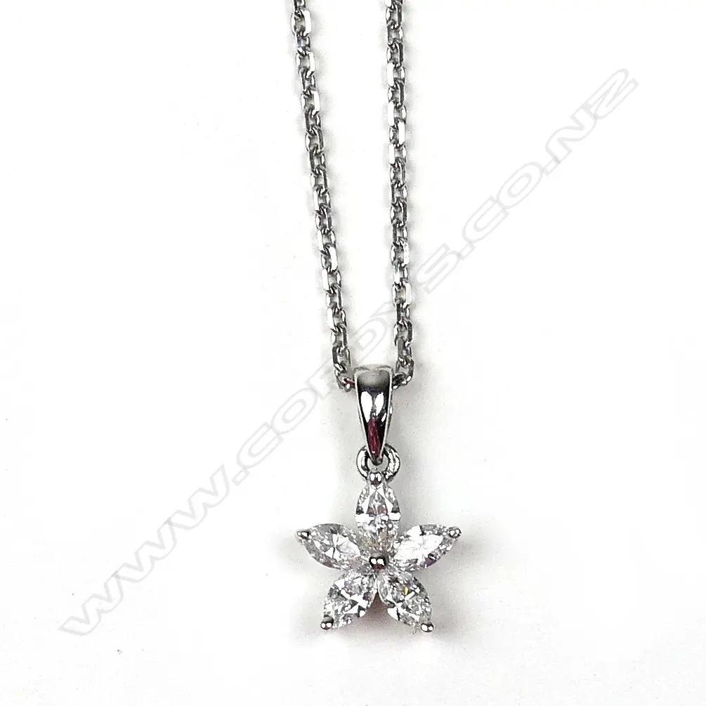 An 18ct. white gold and diamond star form pendant on an 18ct. fine chain Image 1++