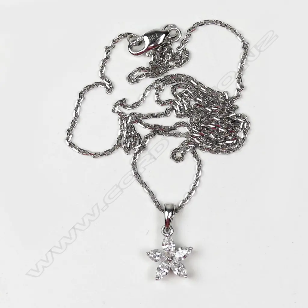 An 18ct. white gold and diamond star form pendant on an 18ct. fine chain Image 1++
