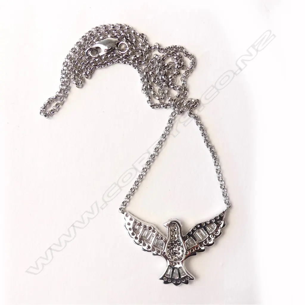 An 18ct white gold and diamond pendant Image 1++