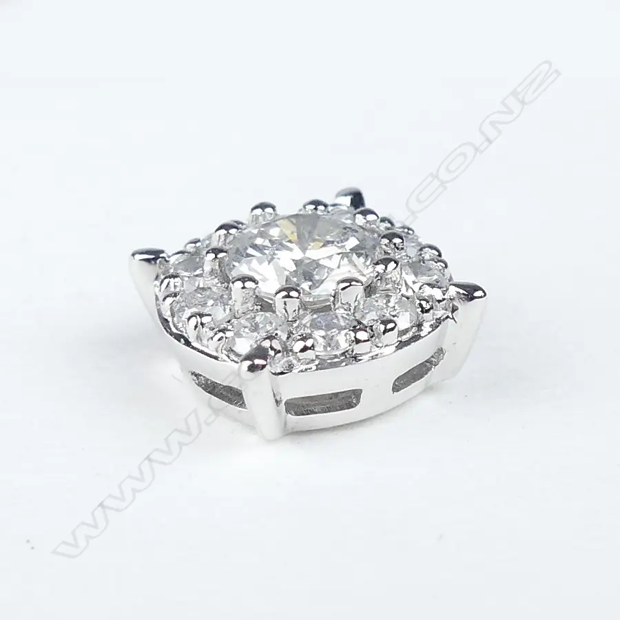 A pair of platinum and diamond halo stud earrings Image 1++