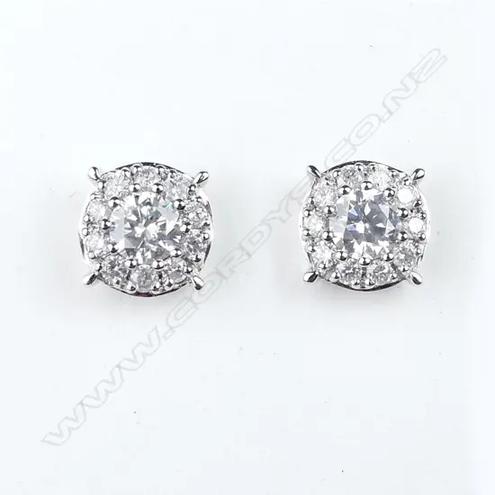 A pair of platinum and diamond halo stud earrings