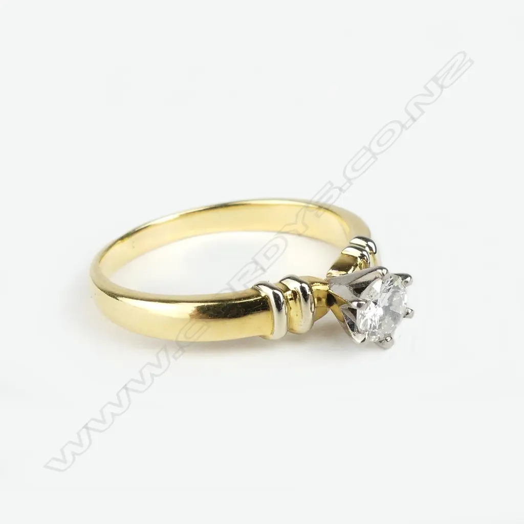 An 18ct. yellow gold and diamond solitaire ring Image 1++