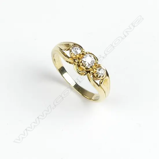 An estate 18ct. yellow gold handmade three diamond dress ring
