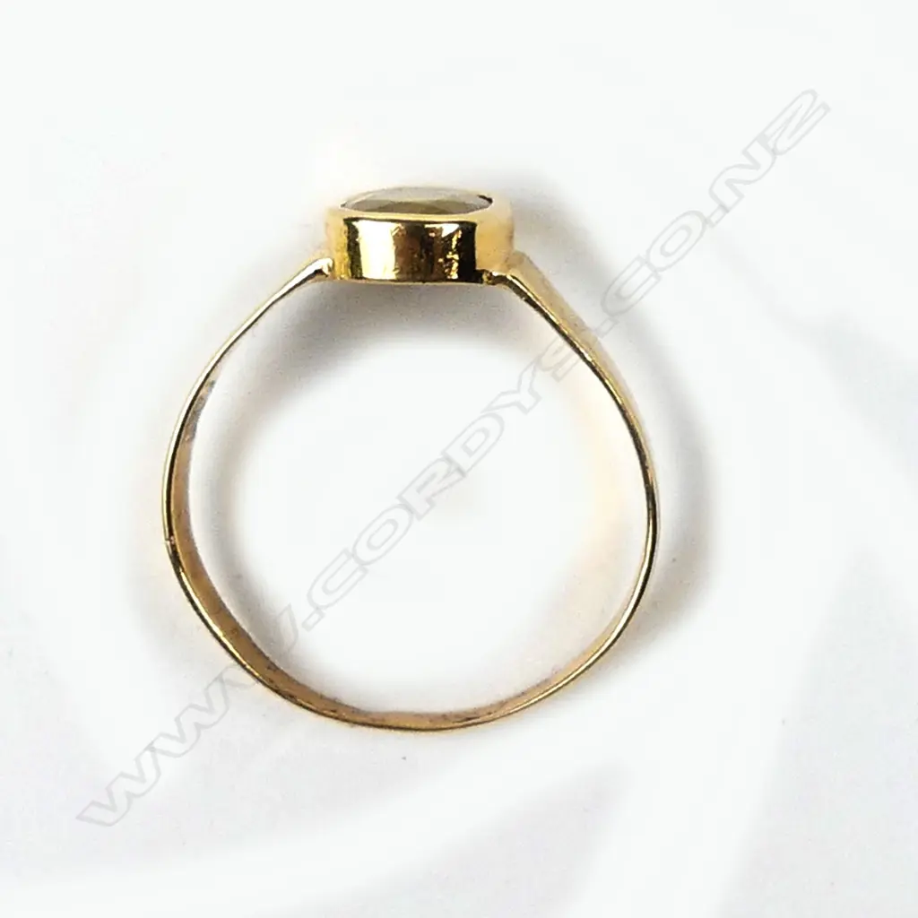 An 18ct gold and golden sapphire ring Image 1++