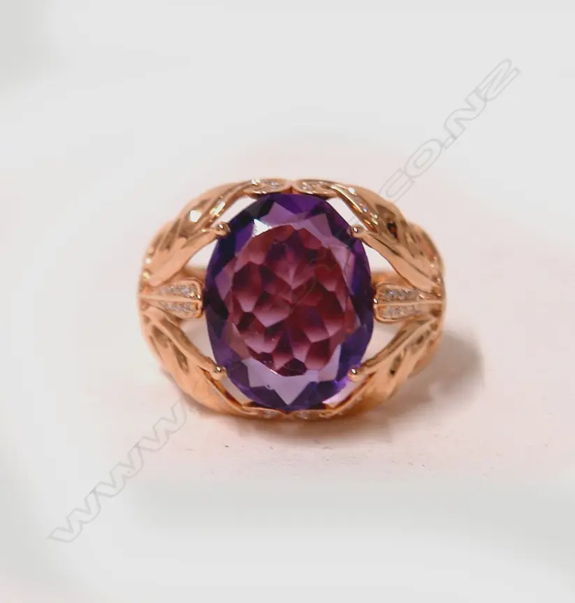 An 18ct. rose gold modern large amethyst and diamond dress ring Image 1++