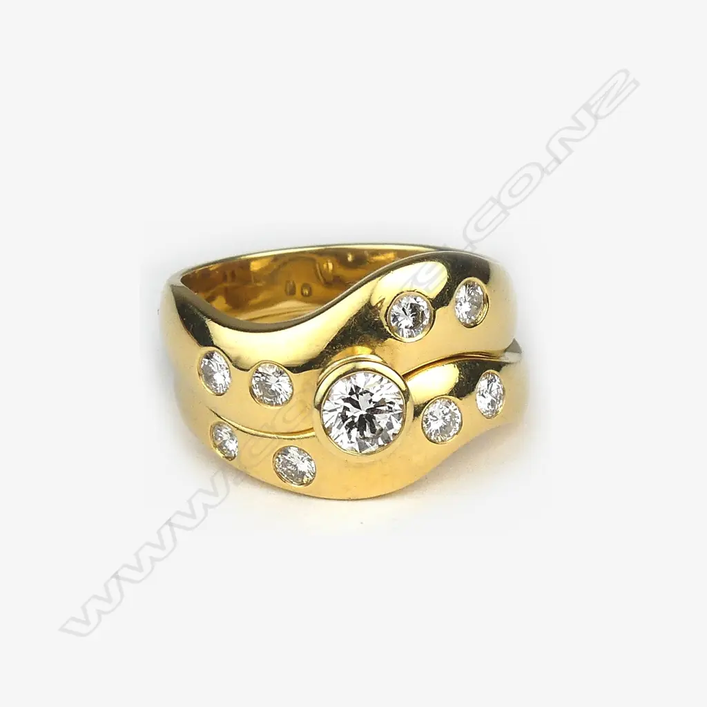 An 18ct. yellow gold and diamond solitaire and wedding ring set Image 1++