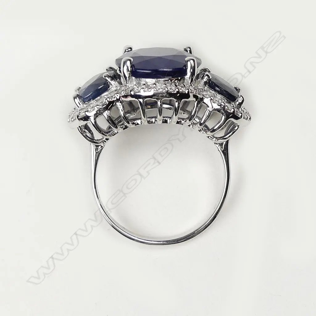 A 14ct white gold sapphire and diamond trilogy ring Image 1++