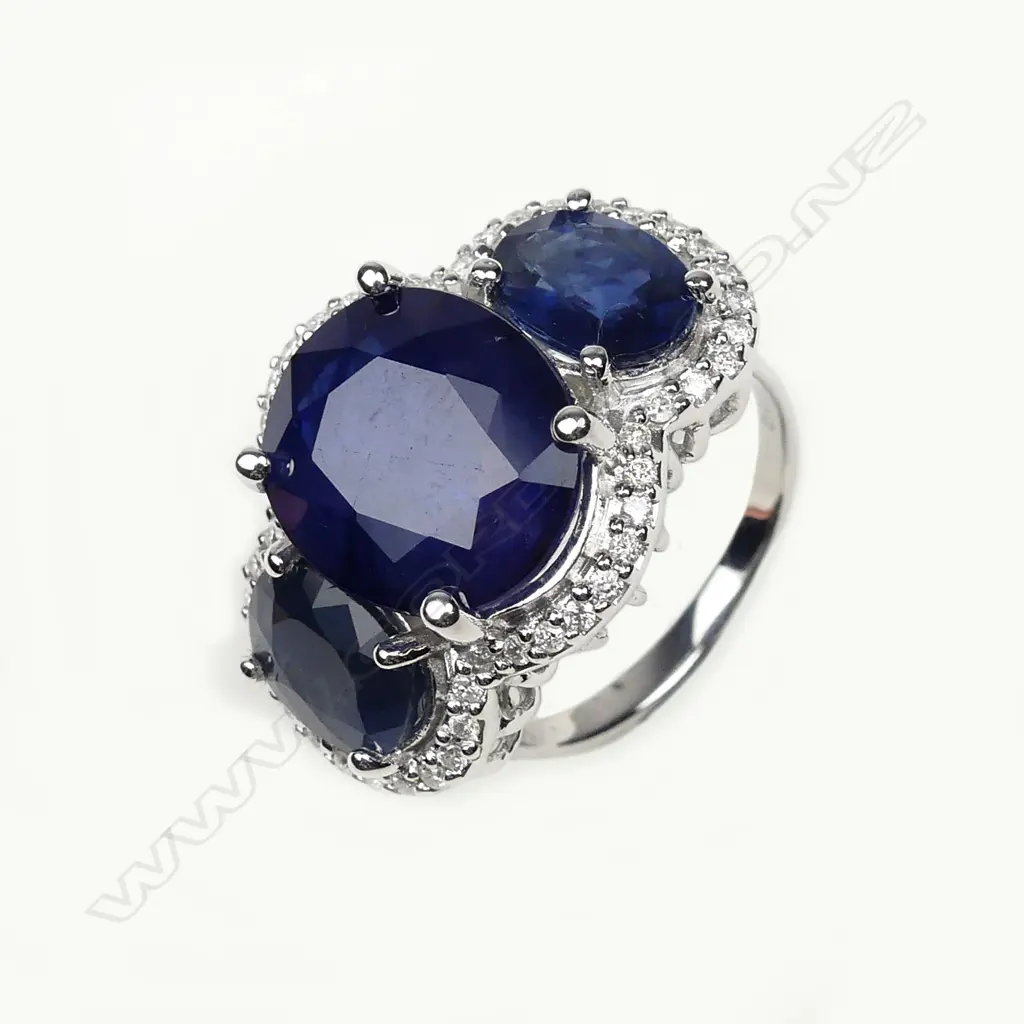 A 14ct white gold sapphire and diamond trilogy ring Image 1++