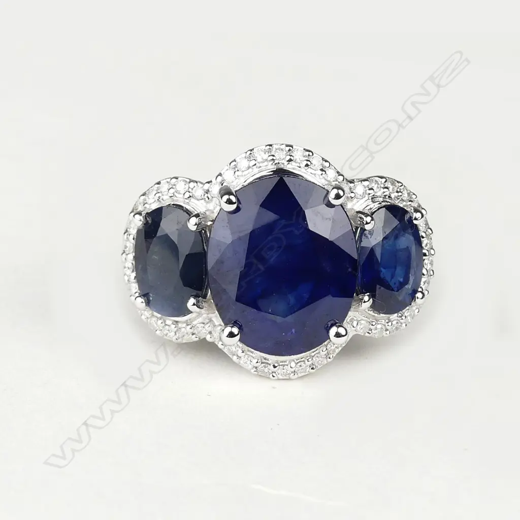 A 14ct white gold sapphire and diamond trilogy ring Image 1++