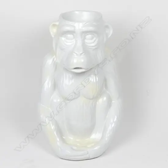 A modern variable white glazed ceramic walking stick stand as a seated chimpanzee