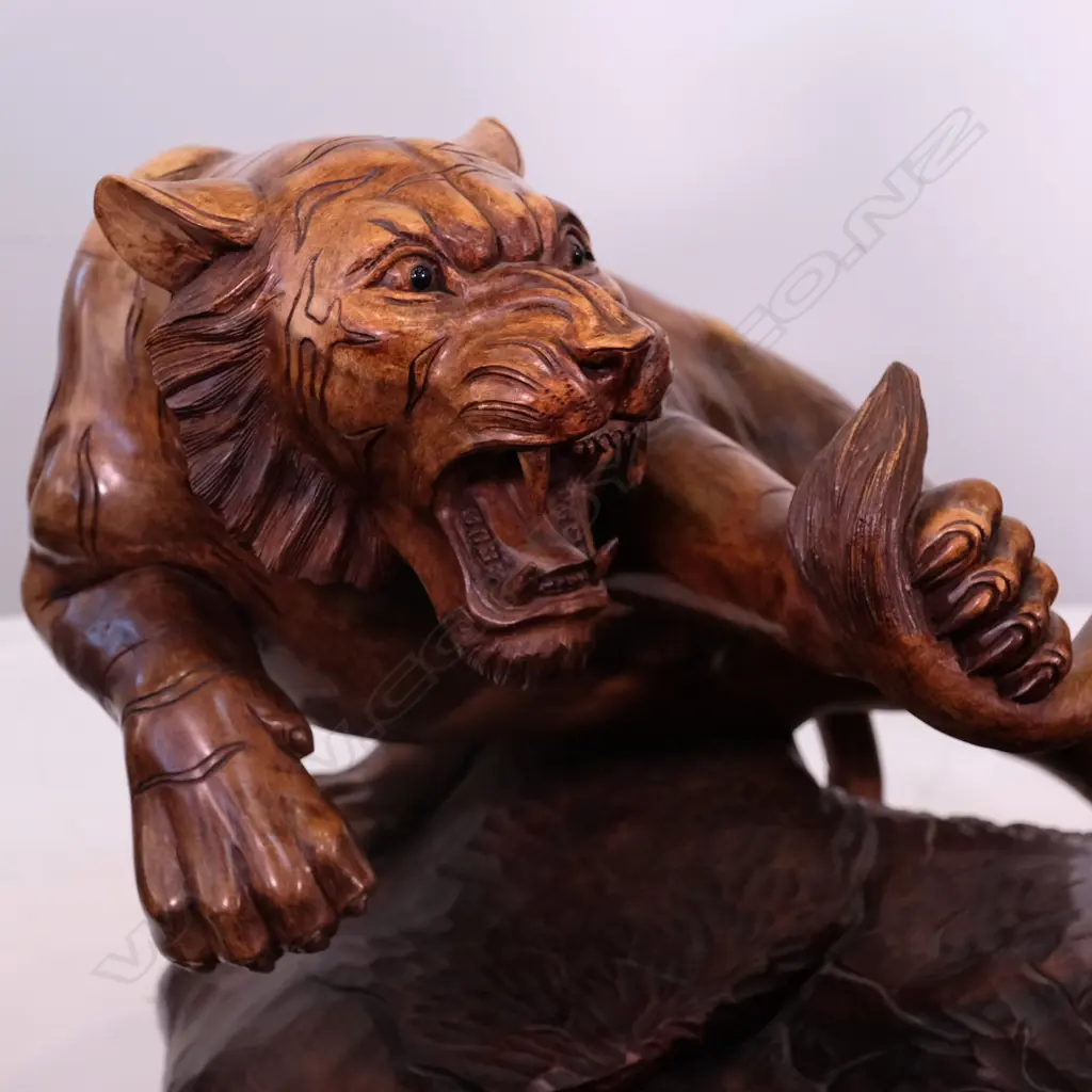 A large carved teak animal group of two tigers attacking a lion Image 1++