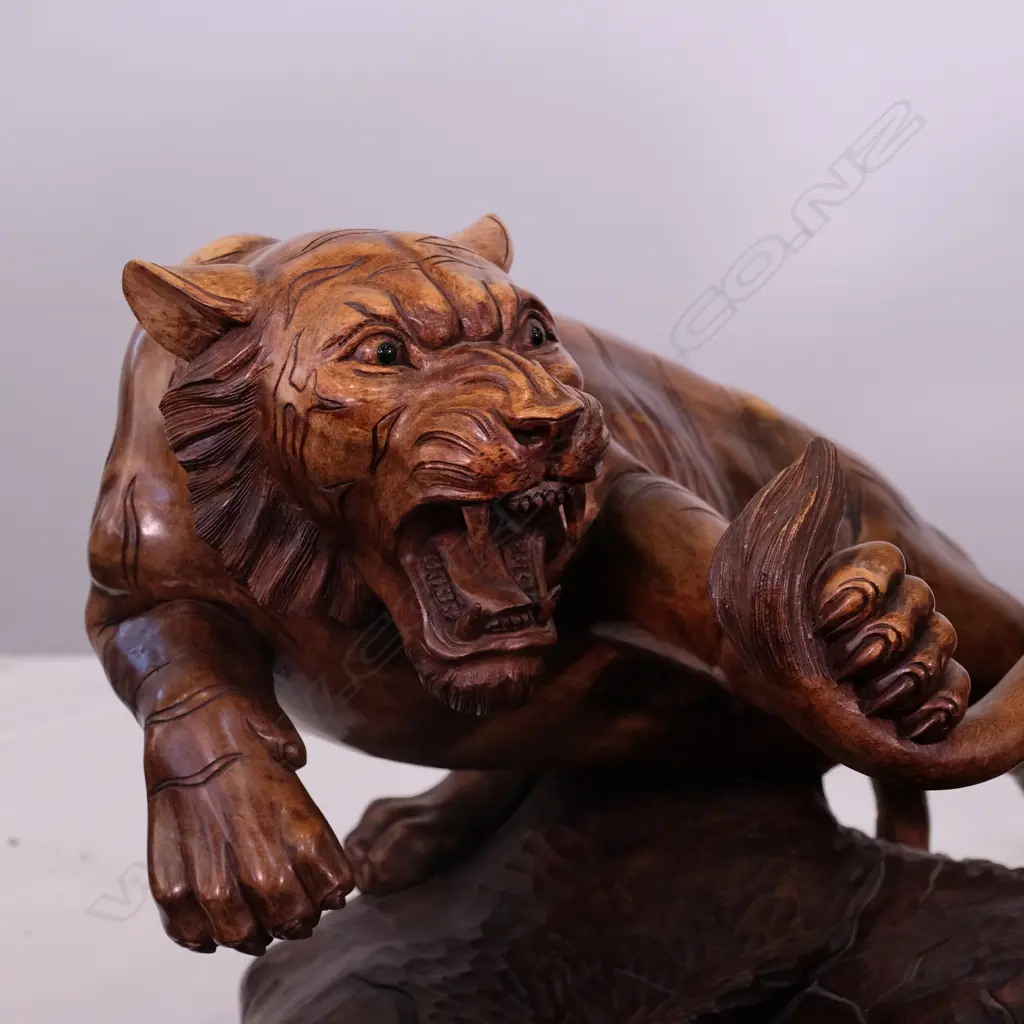 A large carved teak animal group of two tigers attacking a lion Image 1++