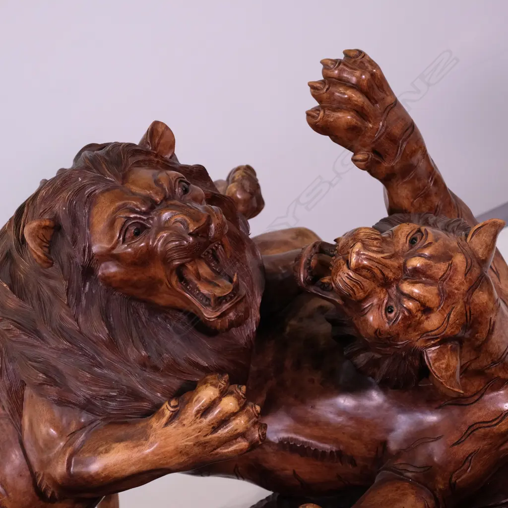A large carved teak animal group of two tigers attacking a lion Image 1++