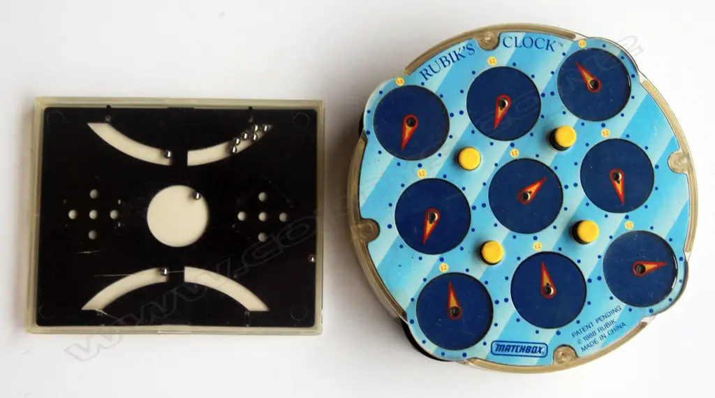 ‘Rubiks’ plastic clock type puzzle and a plastic contained metal ball puzzle Image 1++