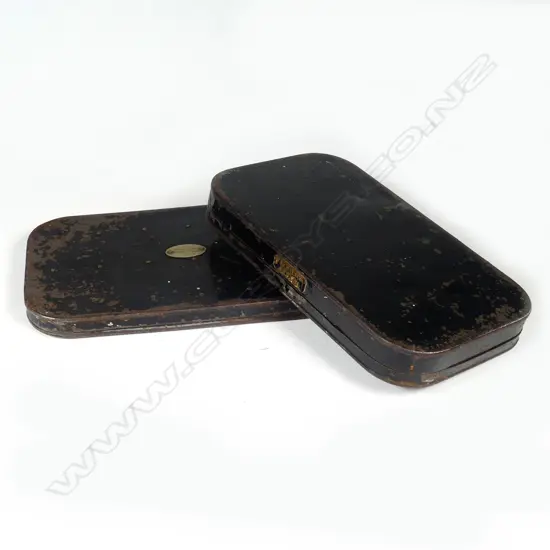 Two late 19thC black Japanned fly boxes with flies