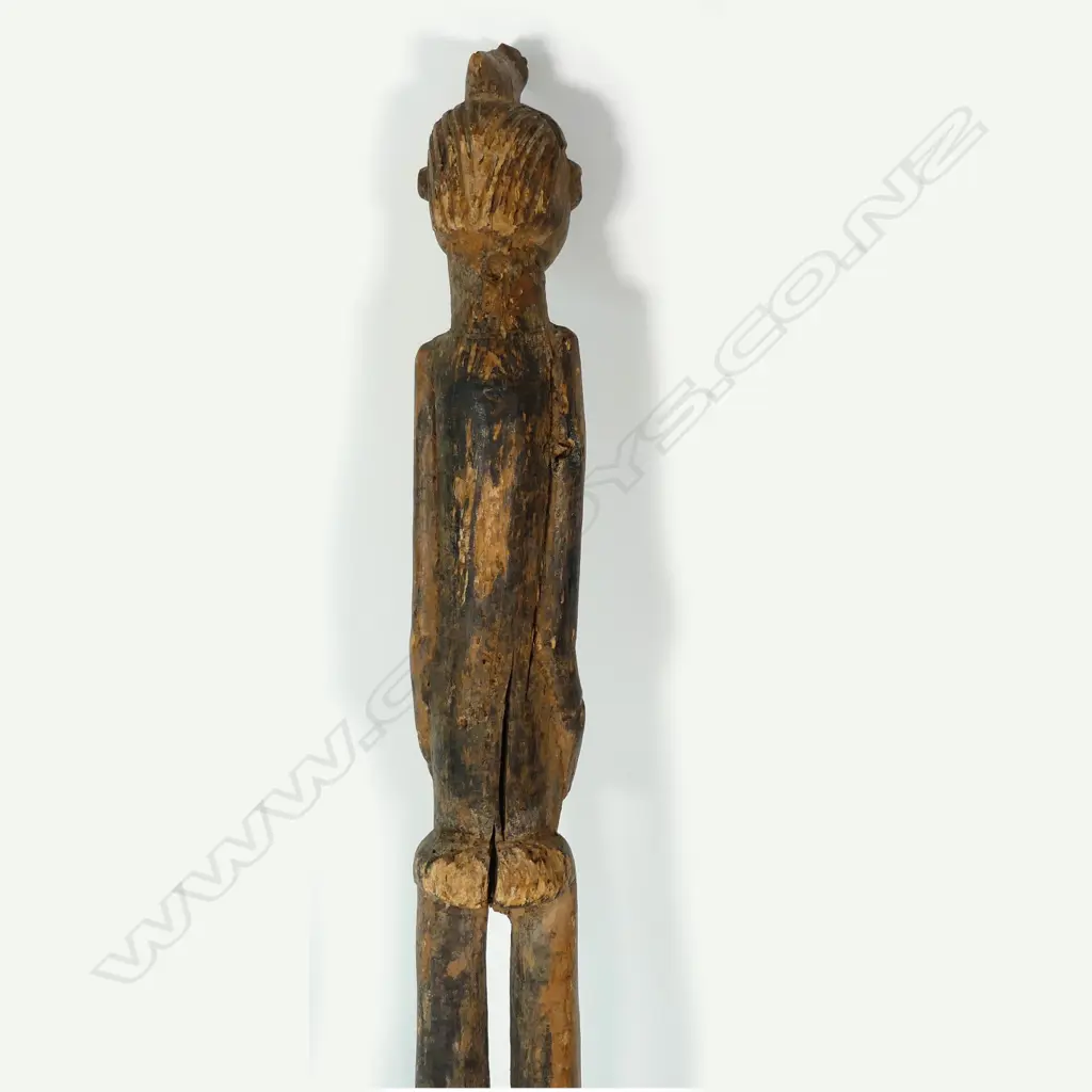 A tall African carved wooden female figure Image 1++