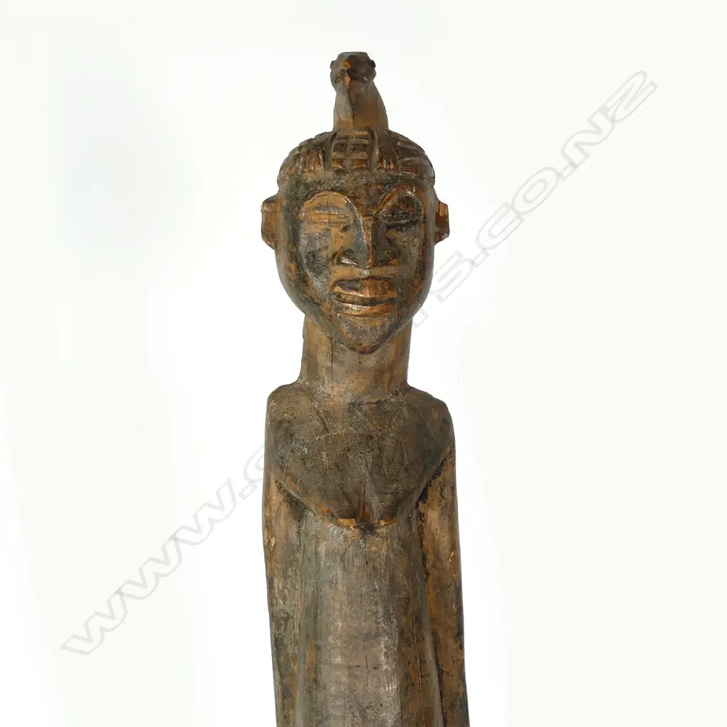 A tall African carved wooden female figure Image 1++