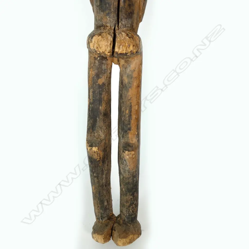 A tall African carved wooden female figure Image 1++
