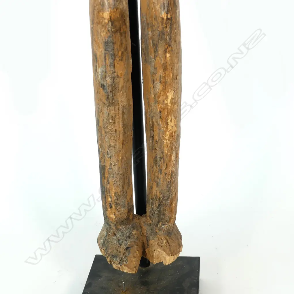 A tall African carved wooden female figure Image 1++
