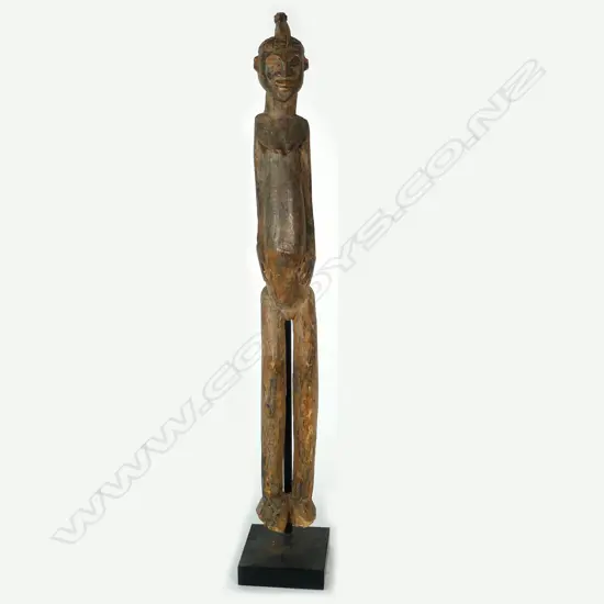 A tall African carved wooden female figure
