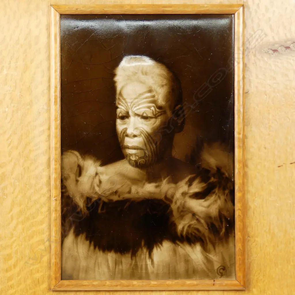 A c.1900 Sherwin & Cotton Māori portrait tile of the chief 'Matene Te Nga', depicted with full moko and in a korowai (cloak), the chief of Ngati Maru iwi, entitled top left, the artist George Cartlidge’s monogram bottom right, maker's marks to reverse. 225 x 150mm.Professional restoration, in old rewarewa frame, the reverse with outline and starting of Māori carved detail. Image 1++