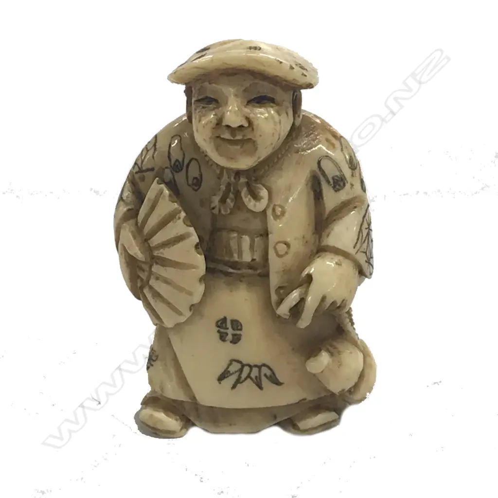 A Japanese ivory netsuke of a man Image 1++