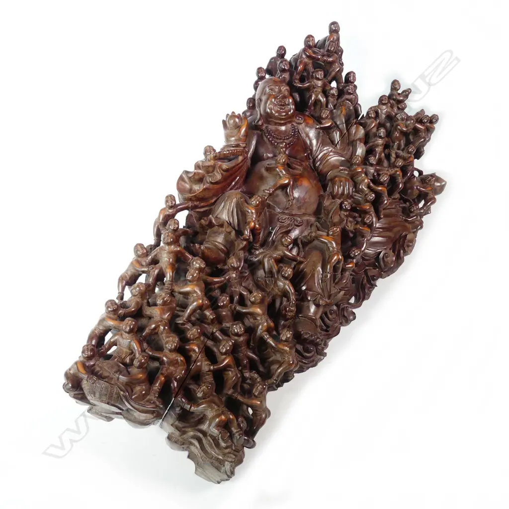 A vintage wood carving of a reclining laughing Buddha Image 1++