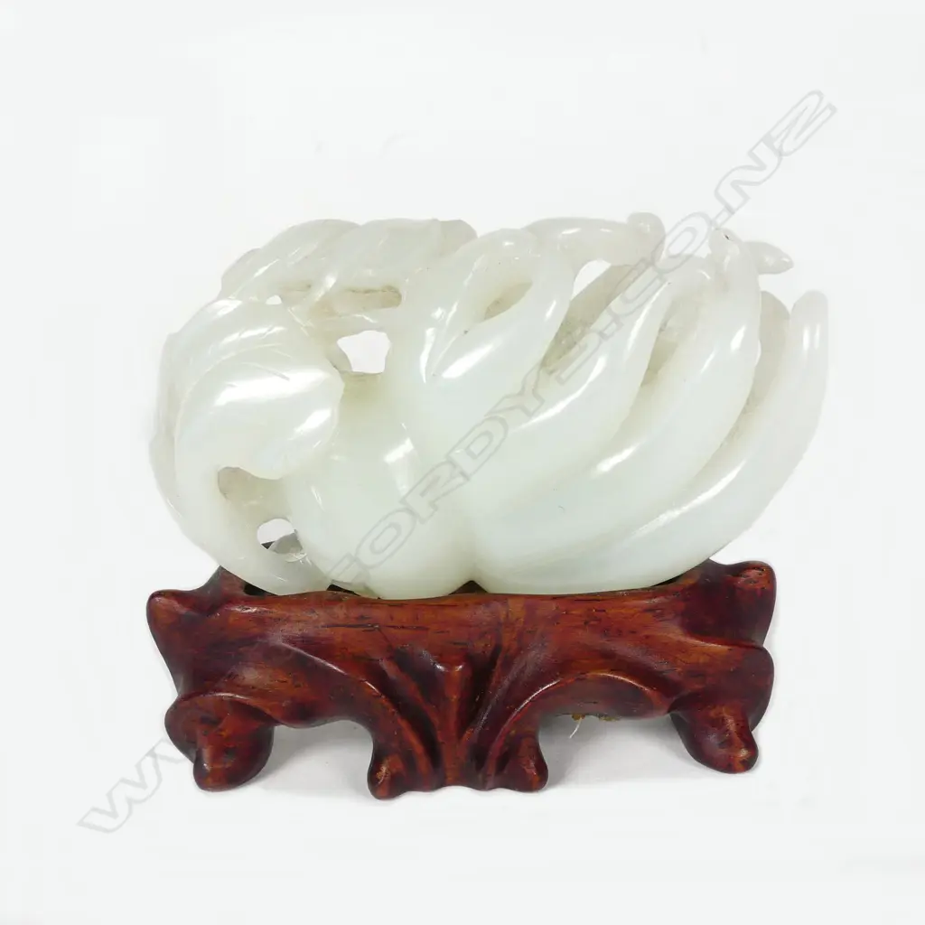 A Chinese pale green jade handling piece carved as a finger citron Image 1++