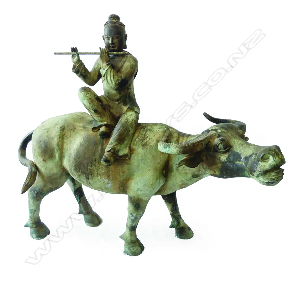 An old and well modelled bronze statue depicting the Zen Buddhist expression of spirit - Riding the Bull Home Image 1++