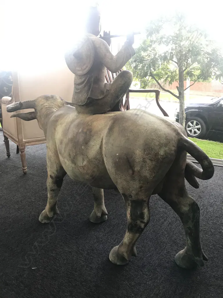 An old and well modelled bronze statue depicting the Zen Buddhist expression of spirit - Riding the Bull Home Image 1++
