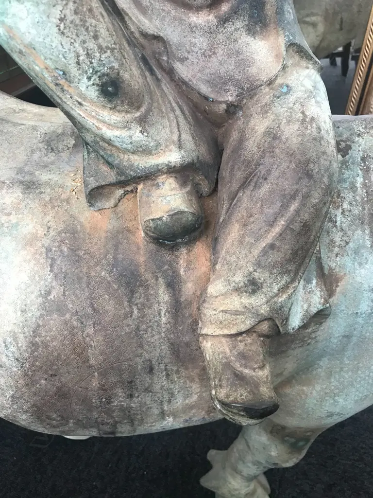 An old and well modelled bronze statue depicting the Zen Buddhist expression of spirit - Riding the Bull Home Image 1++