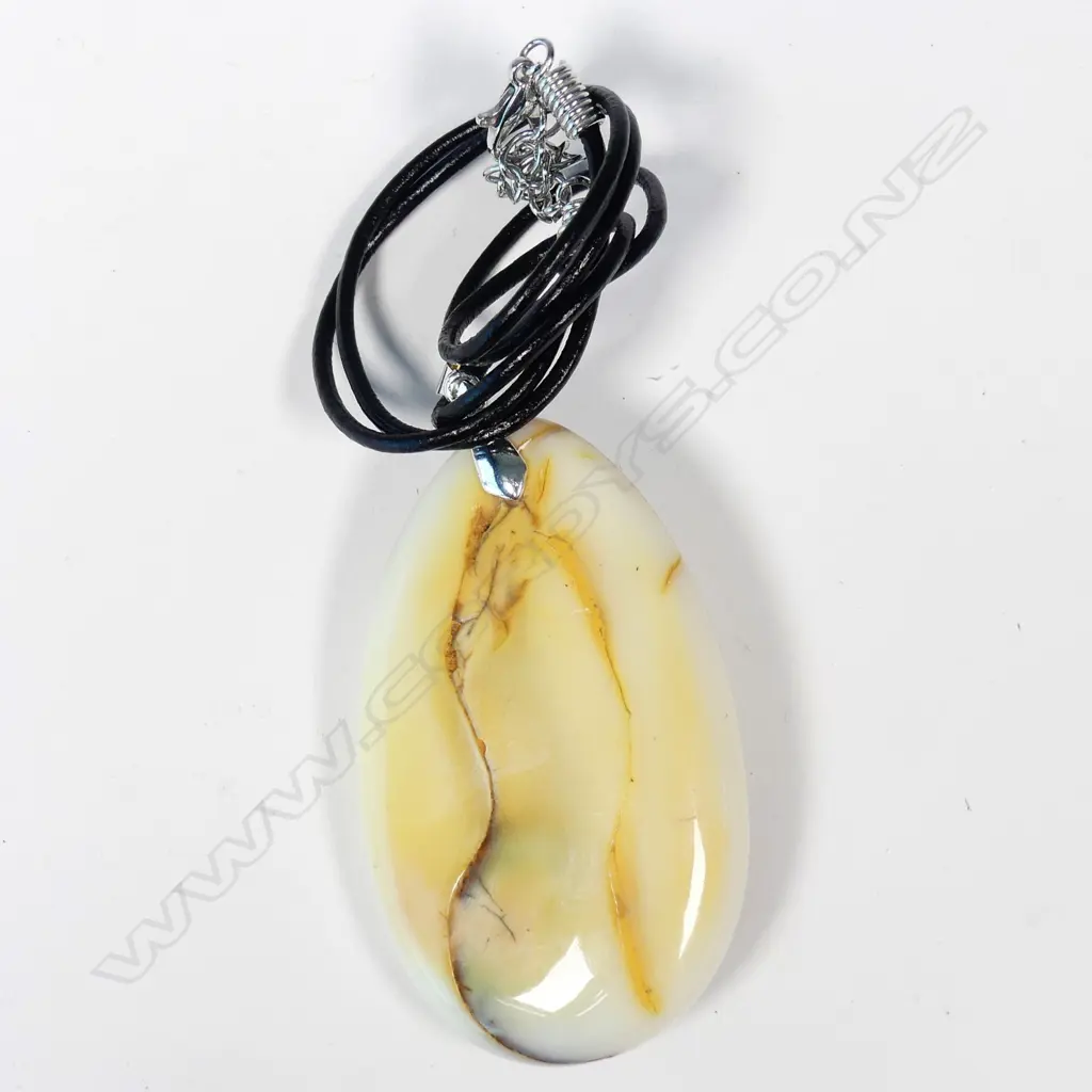 An uncommon mottled white amber pendant Image 1++