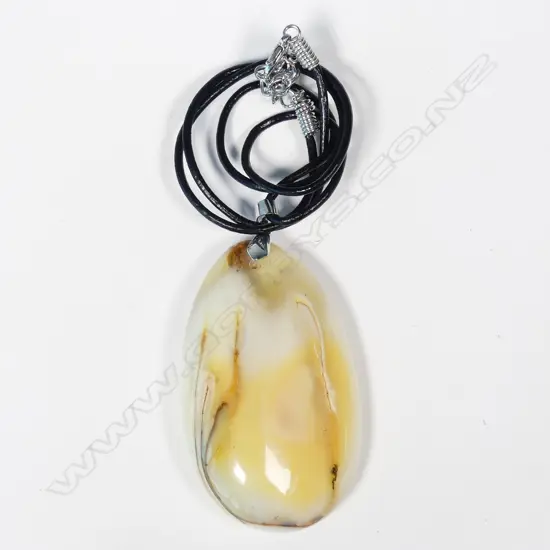 An uncommon mottled white amber pendant