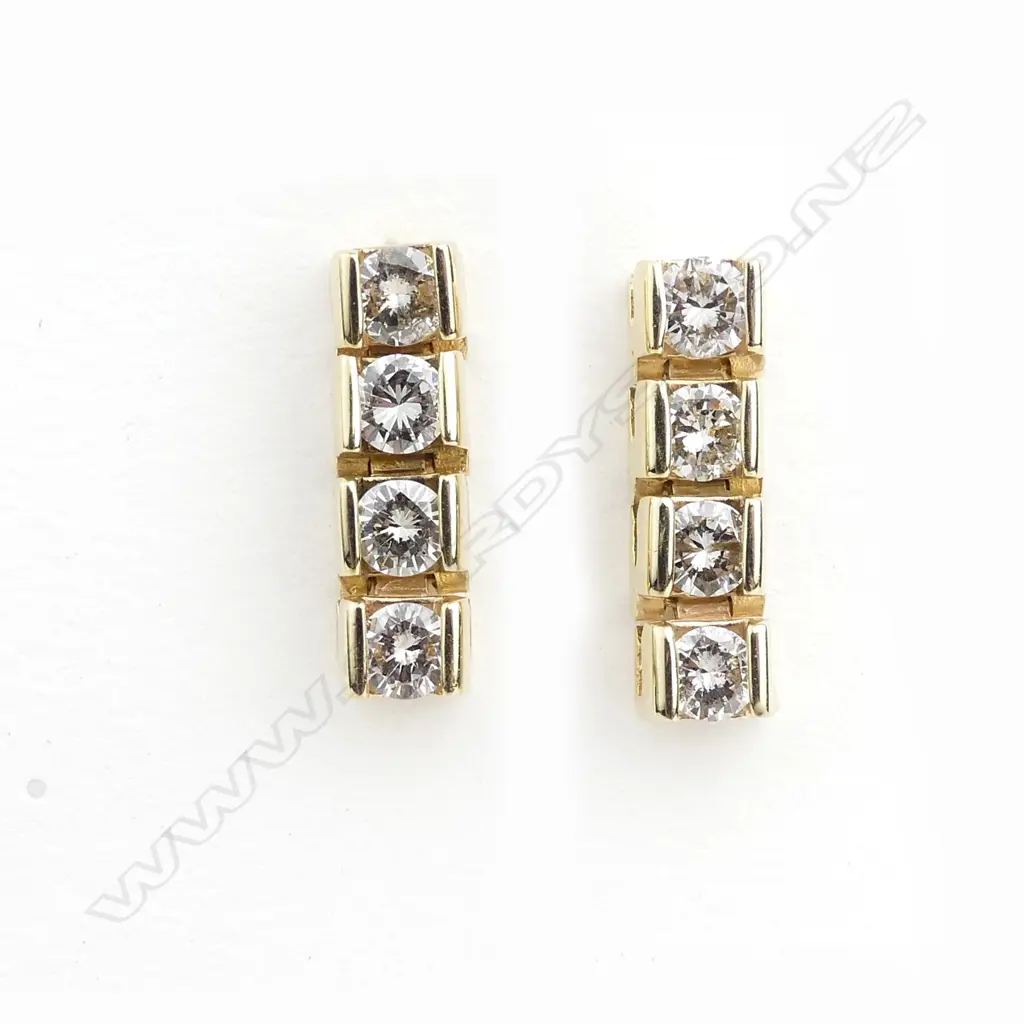 An 18ct yellow gold and diamond tennis bracelet and earring suite Image 1++