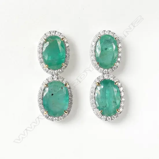 A pair of platinum emerald and diamond drop earrings