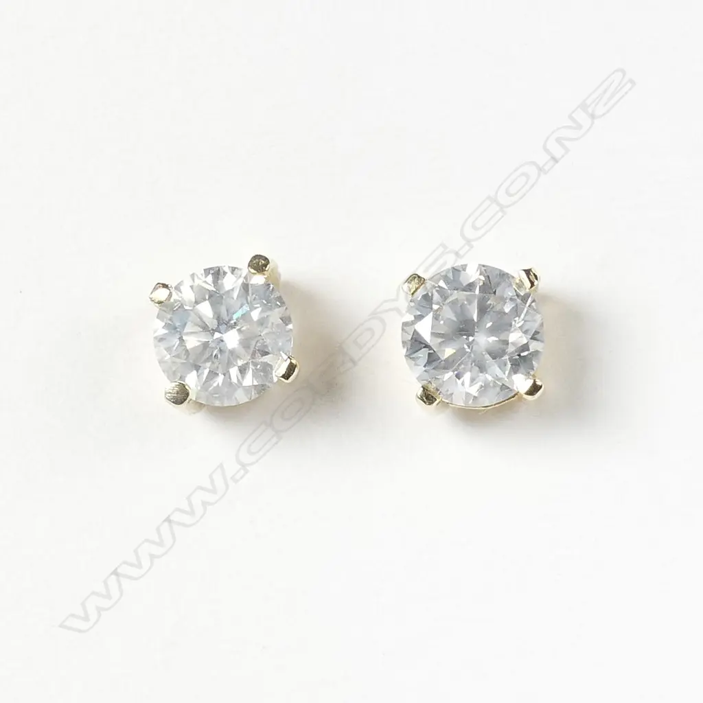 A pair of 18ct gold and diamond stud earrings Image 1++