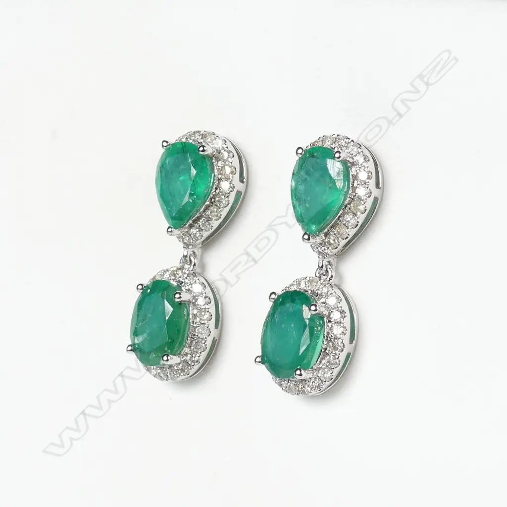 A pair of 14ct white gold emerald and diamond drop earrings Image 1++