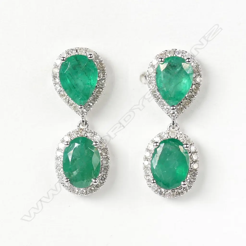 A pair of 14ct white gold emerald and diamond drop earrings Image 1++