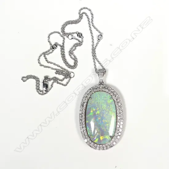 An impressive 14ct white gold opal and diamond pendant