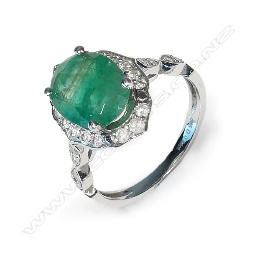 A 14ct white gold emerald and diamond dress ring Image 1++