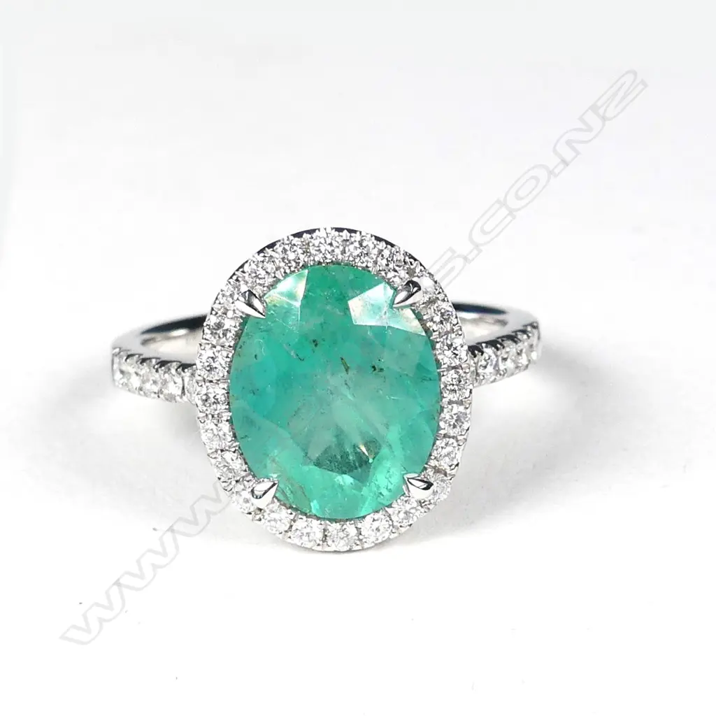 A platinum emerald and diamond ring Image 1++