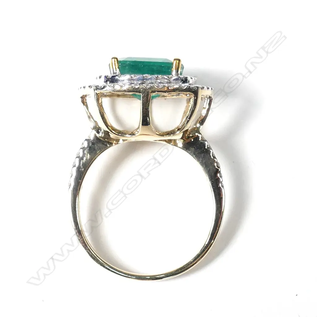 A 14ct gold emerald and diamond double halo ring Image 1++