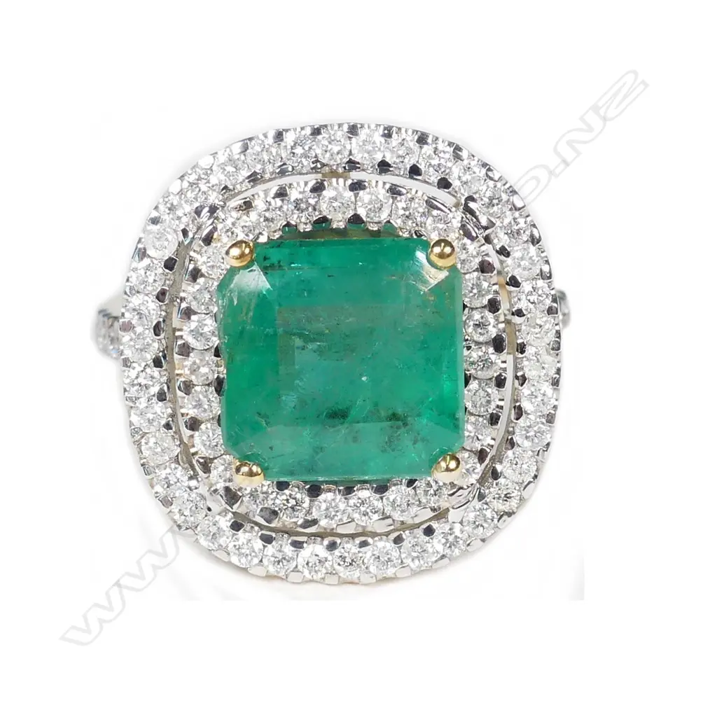 A 14ct gold emerald and diamond double halo ring Image 1++