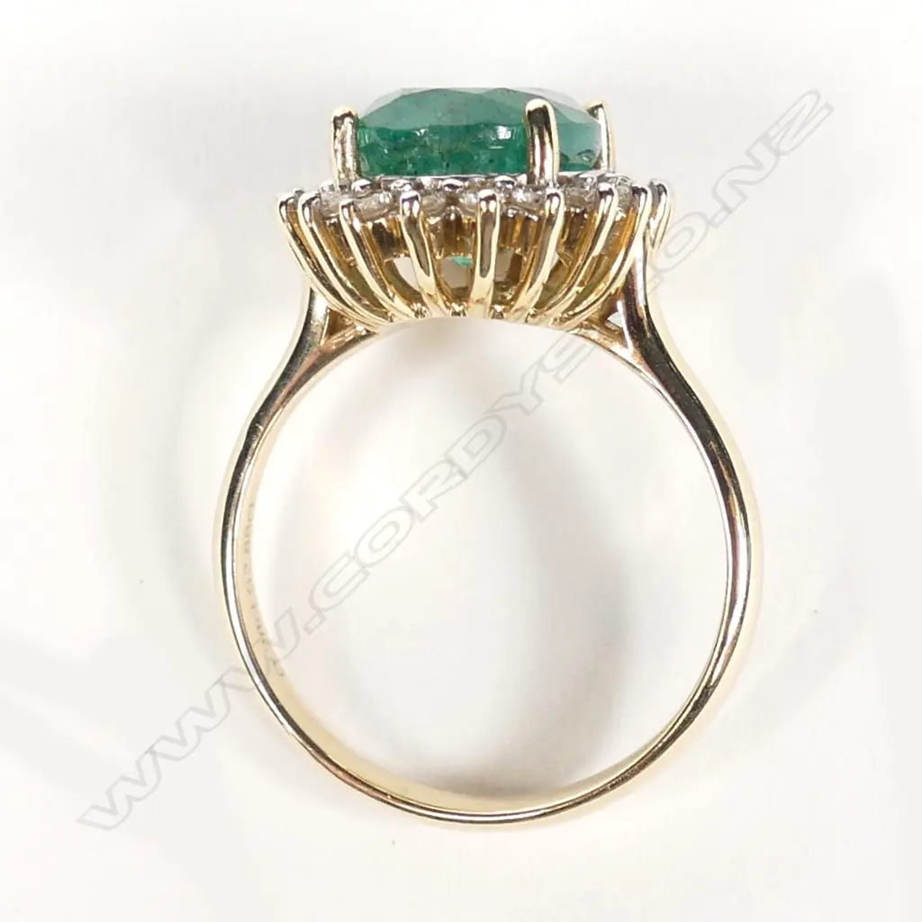 A 14ct gold emerald and diamond ring Image 1++
