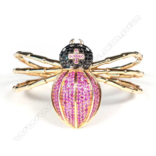 An unusual 18ct rose gold diamond and ruby bangle