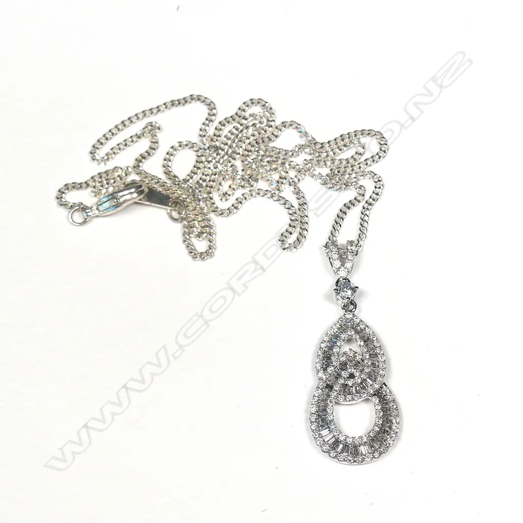 An 18ct white gold and diamond pendant Image 1++
