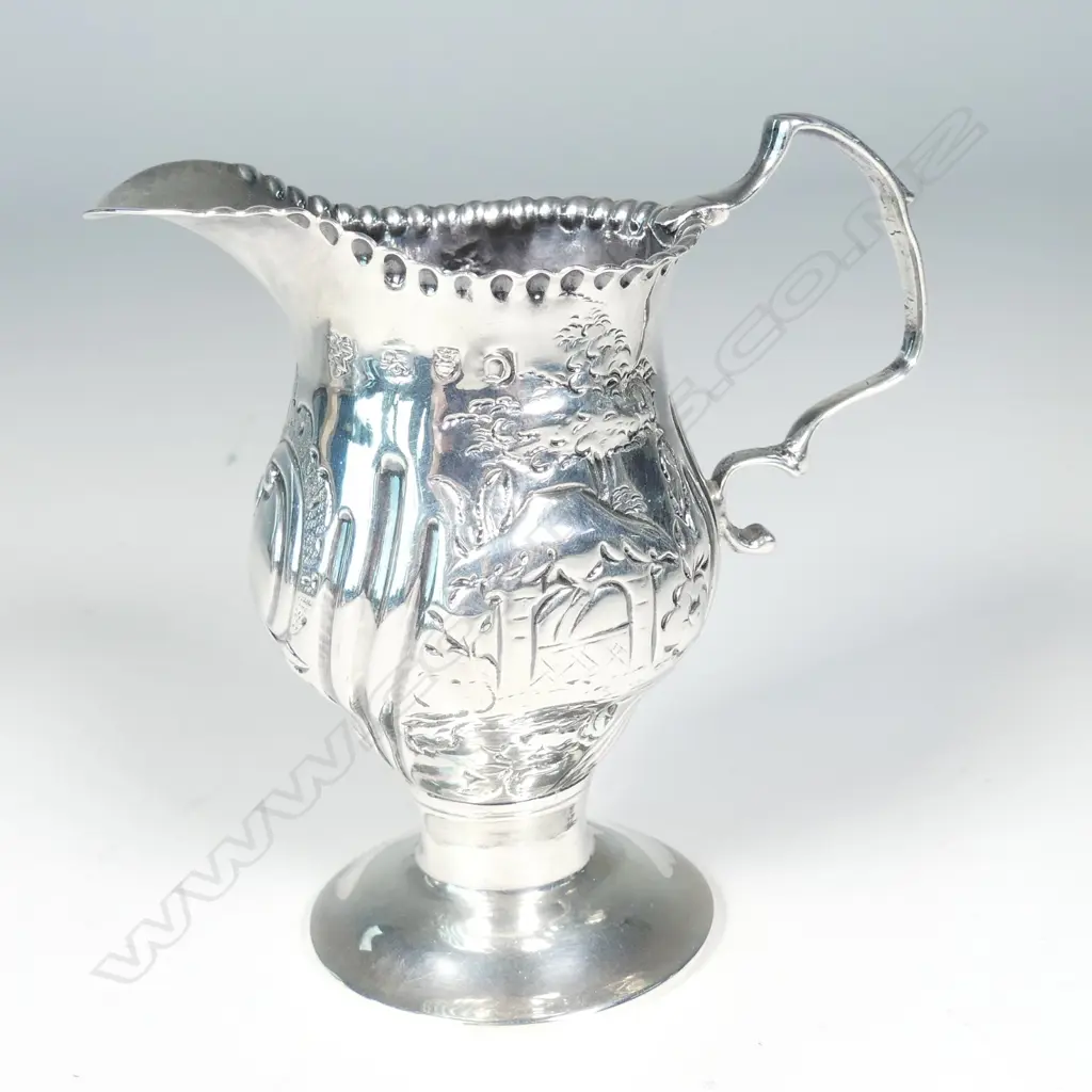 A George III silver helmet cream jug Image 1++