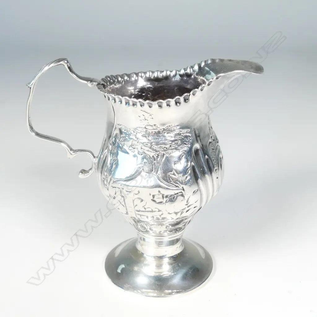 A George III silver helmet cream jug Image 1++